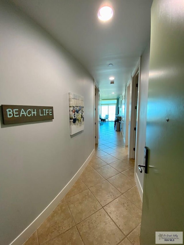 hall featuring light tile patterned flooring