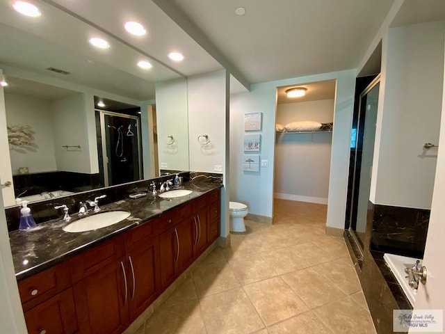 full bathroom featuring tile patterned flooring, vanity, independent shower and bath, and toilet