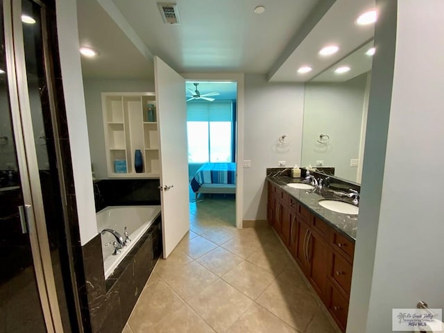 bathroom with a relaxing tiled tub, vanity, tile patterned flooring, and ceiling fan