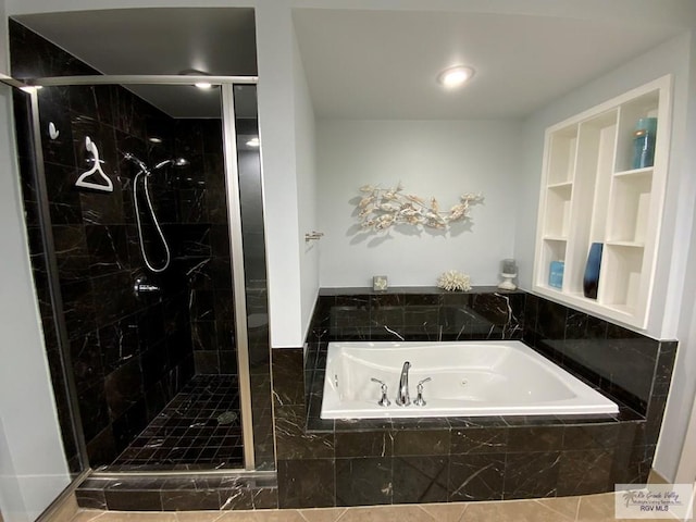 bathroom featuring shower with separate bathtub