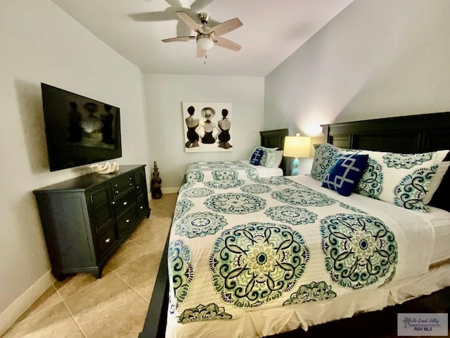 bedroom with ceiling fan and light tile patterned floors