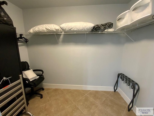 spacious closet with light tile patterned floors