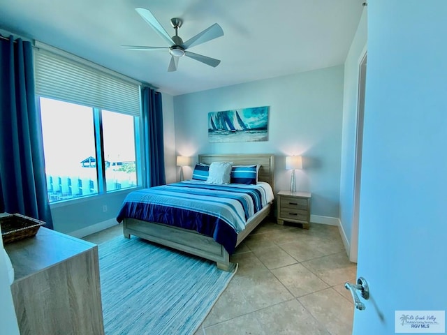 tiled bedroom featuring ceiling fan