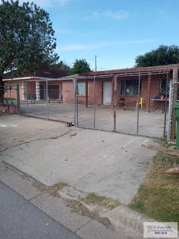 view of gate with an outbuilding