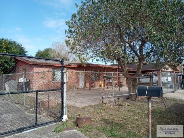 exterior space with fence and brick siding