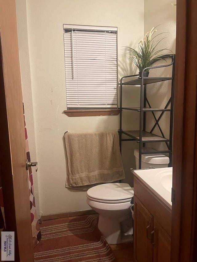 bathroom featuring vanity and toilet