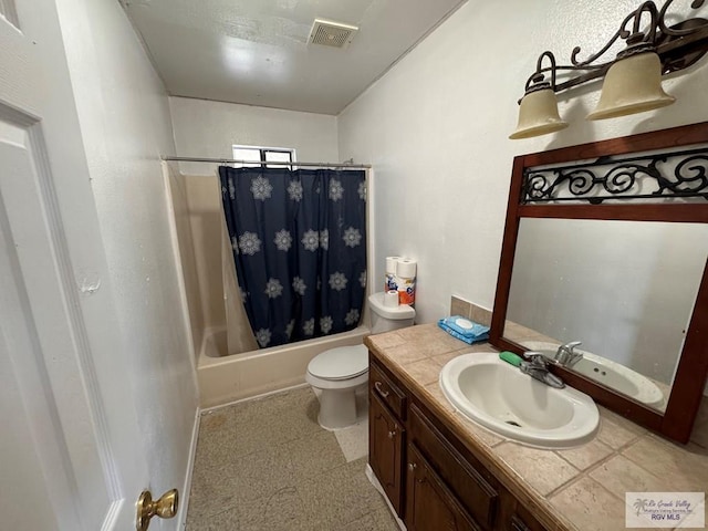 full bathroom featuring vanity, toilet, and shower / tub combo with curtain