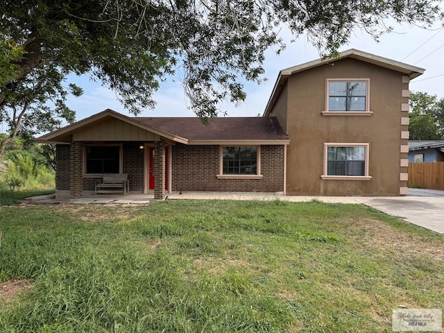 view of front of house featuring a patio area and a front lawn