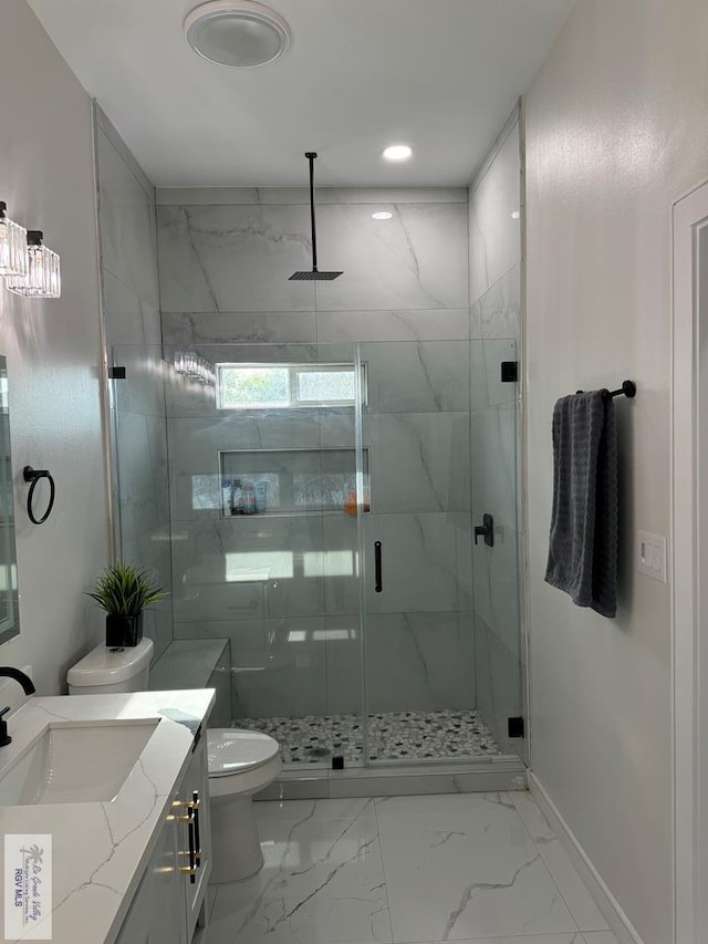 bathroom featuring vanity, toilet, and an enclosed shower