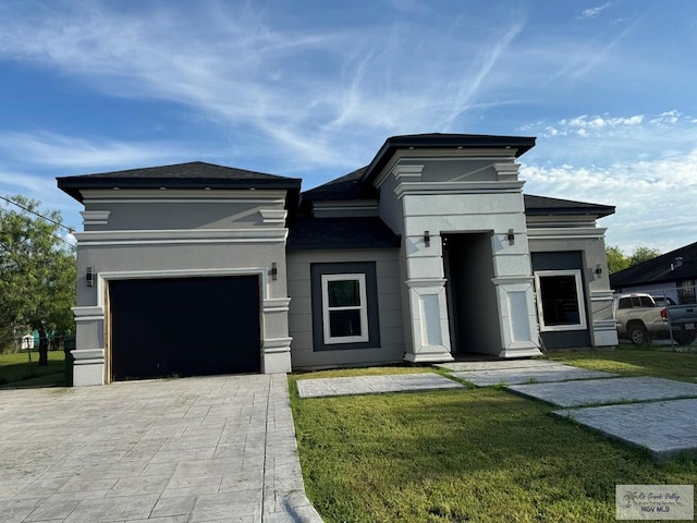 view of front of house featuring a garage and a front lawn