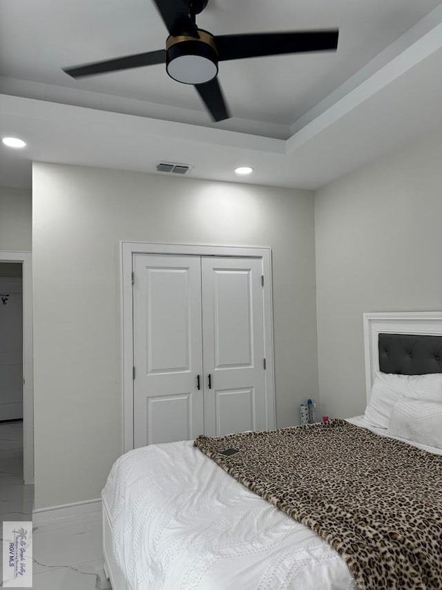 bedroom featuring ceiling fan and a closet