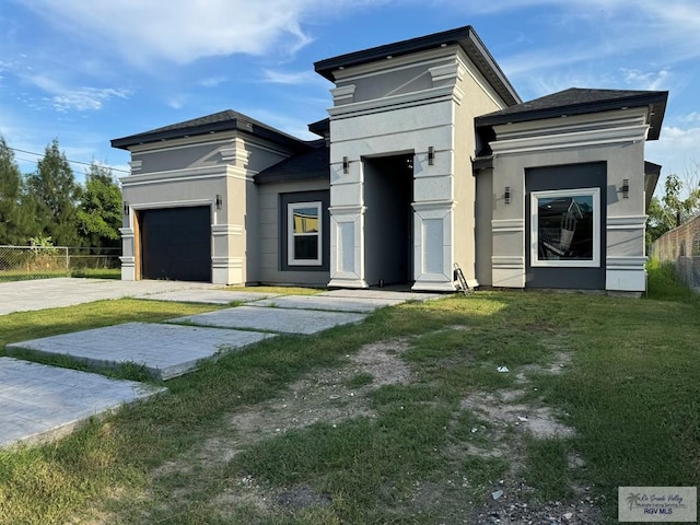 contemporary house with a front lawn and a garage