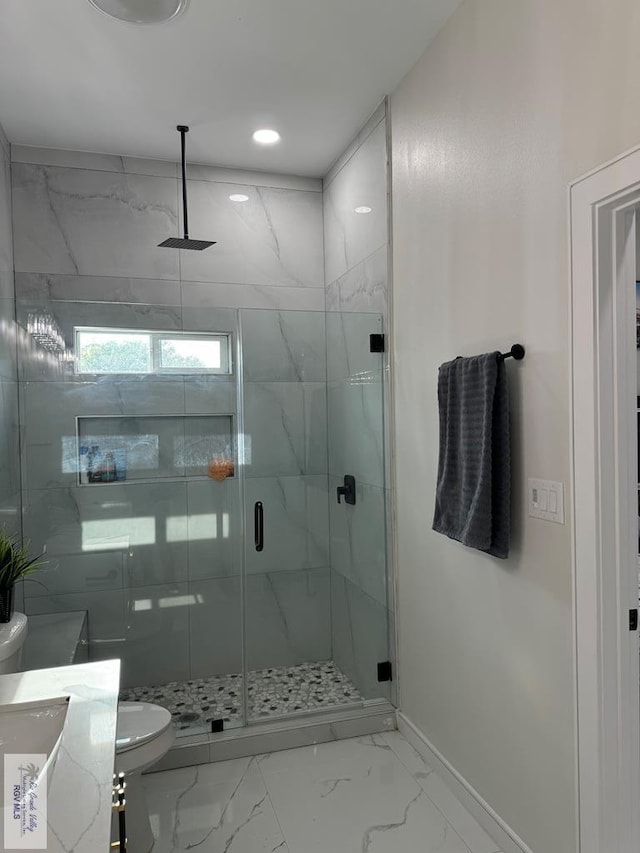 bathroom with vanity, toilet, and a shower with shower door