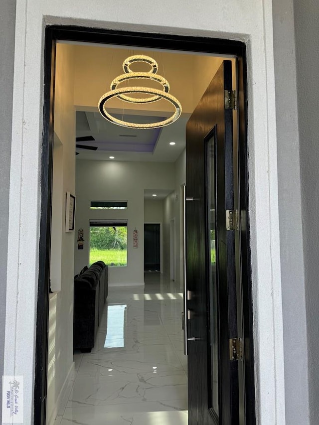 hallway featuring a notable chandelier