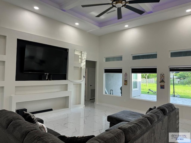 living room with ceiling fan and a high ceiling