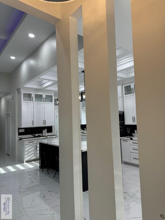 interior space featuring beamed ceiling and coffered ceiling