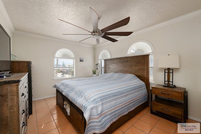 1302 Harbor Island Dr, Port Isabel, TX 78526 - bedroom with light tile patterned floors, crown molding, ceiling fan, and a textured ceiling