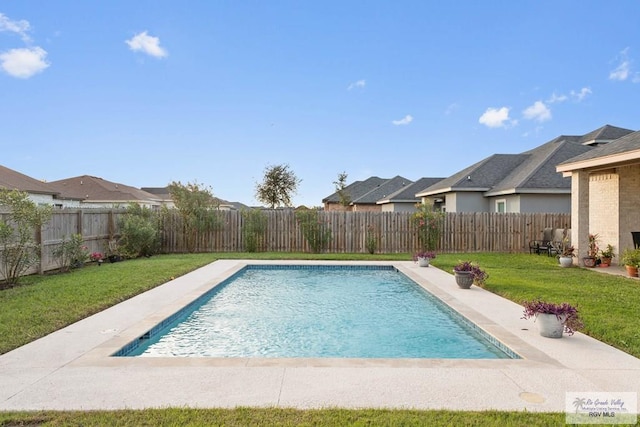 view of swimming pool featuring a yard, a fenced backyard, a fenced in pool, and a residential view