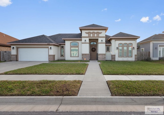 prairie-style home featuring fence, driveway, an attached garage, stucco siding, and a front lawn