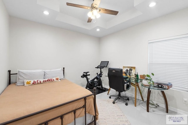 bedroom with recessed lighting and a tray ceiling