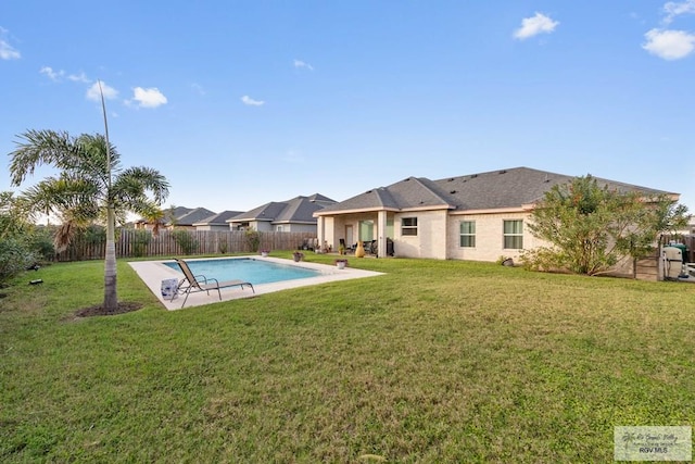 view of pool featuring a lawn, a patio, a fenced backyard, and a fenced in pool