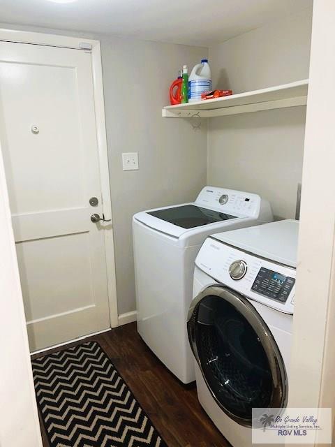 clothes washing area featuring independent washer and dryer and dark wood-type flooring