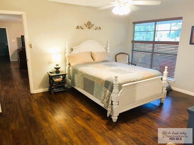 bedroom with ceiling fan and dark hardwood / wood-style flooring