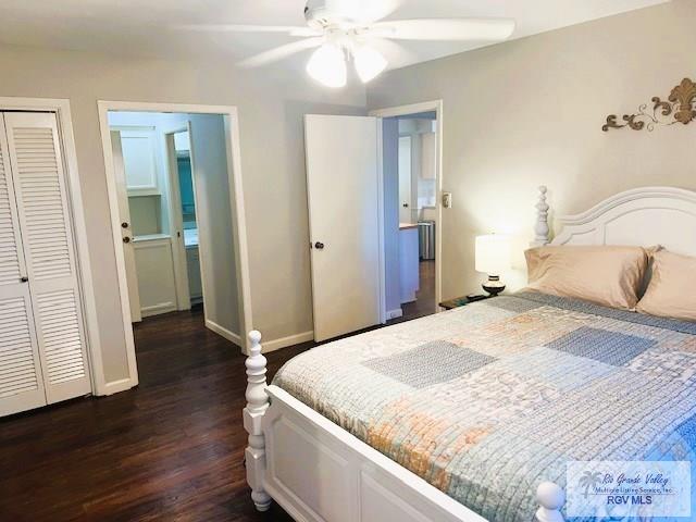 bedroom featuring ceiling fan, dark hardwood / wood-style flooring, and a closet