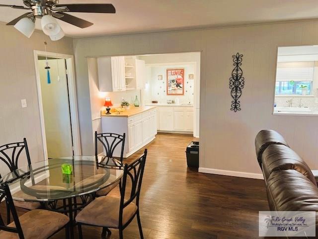 dining room featuring ceiling fan, dark hardwood / wood-style flooring, and ornamental molding