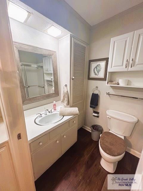 bathroom featuring toilet, vanity, and hardwood / wood-style flooring