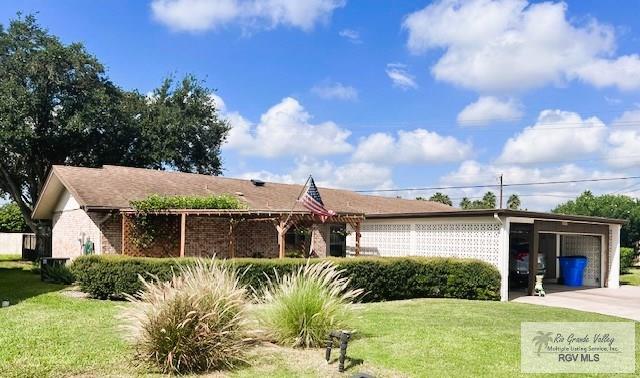 view of front of home with a garage and a front lawn