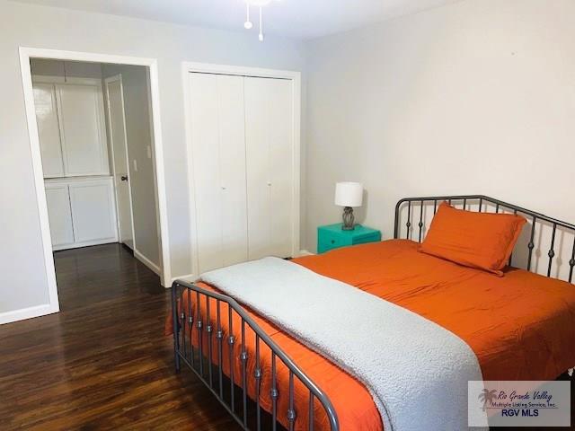 bedroom with a closet and dark hardwood / wood-style flooring