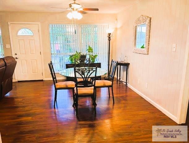 dining room with ceiling fan and dark wood-type flooring