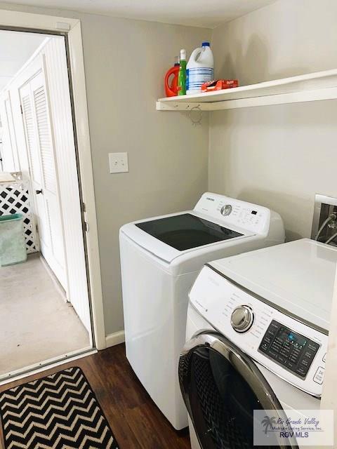 laundry room with dark hardwood / wood-style flooring and separate washer and dryer