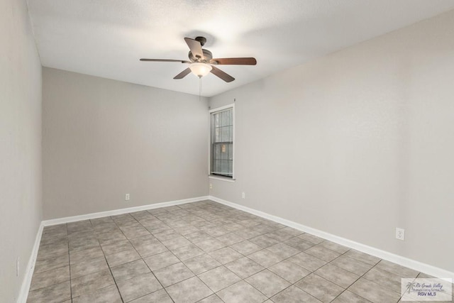 tiled empty room featuring ceiling fan