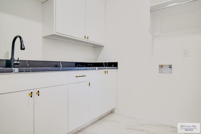 laundry area featuring hookup for a washing machine and cabinets