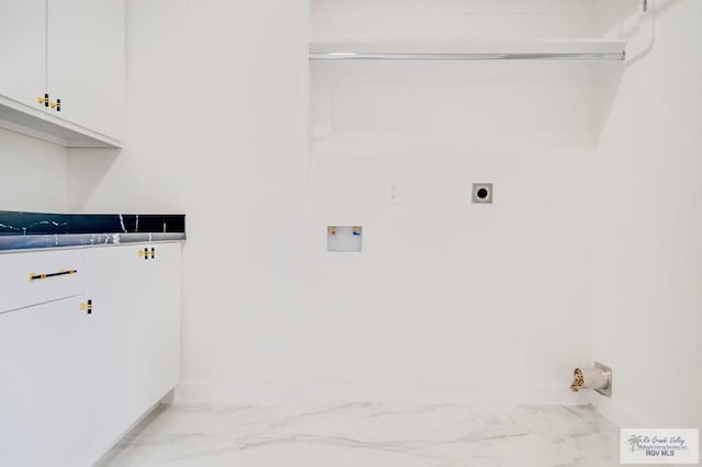 clothes washing area featuring cabinets, hookup for a washing machine, and electric dryer hookup