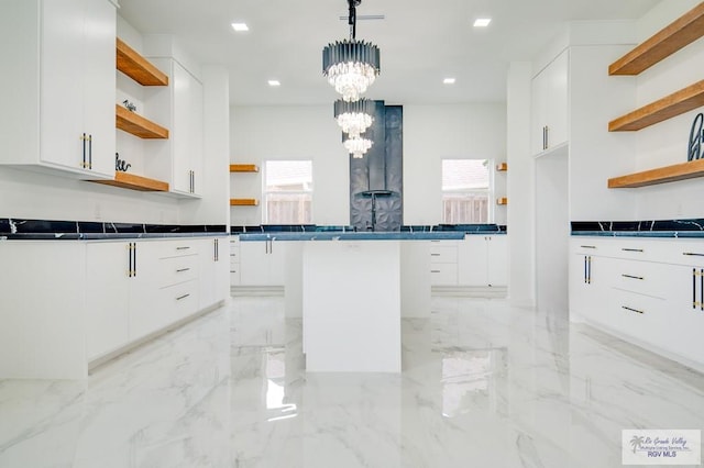 kitchen featuring white cabinets, decorative light fixtures, and a chandelier