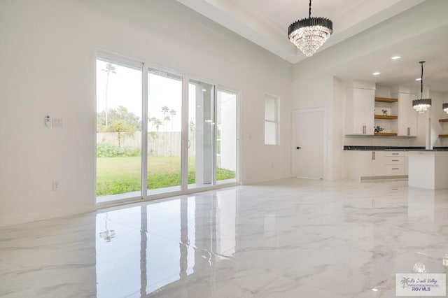 interior space featuring a wealth of natural light and a chandelier