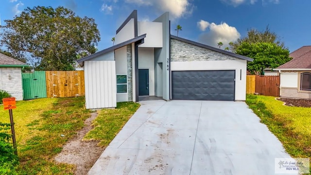 view of front of home with a front yard and a garage