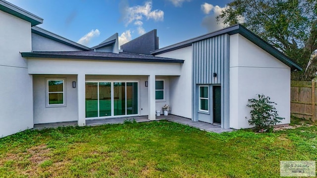 rear view of house with a yard