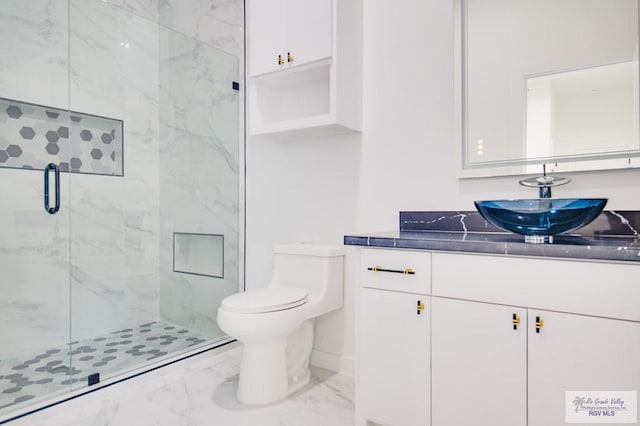 bathroom with walk in shower, vanity, and toilet