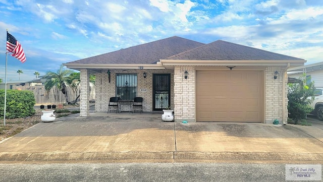 view of front of property with covered porch and a garage