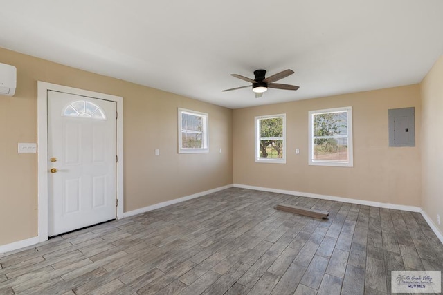 entryway with light wood-type flooring, electric panel, and ceiling fan