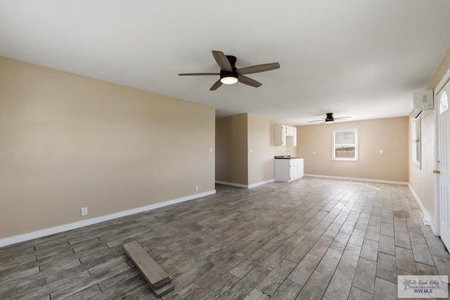 unfurnished living room with an AC wall unit, ceiling fan, and dark wood-type flooring