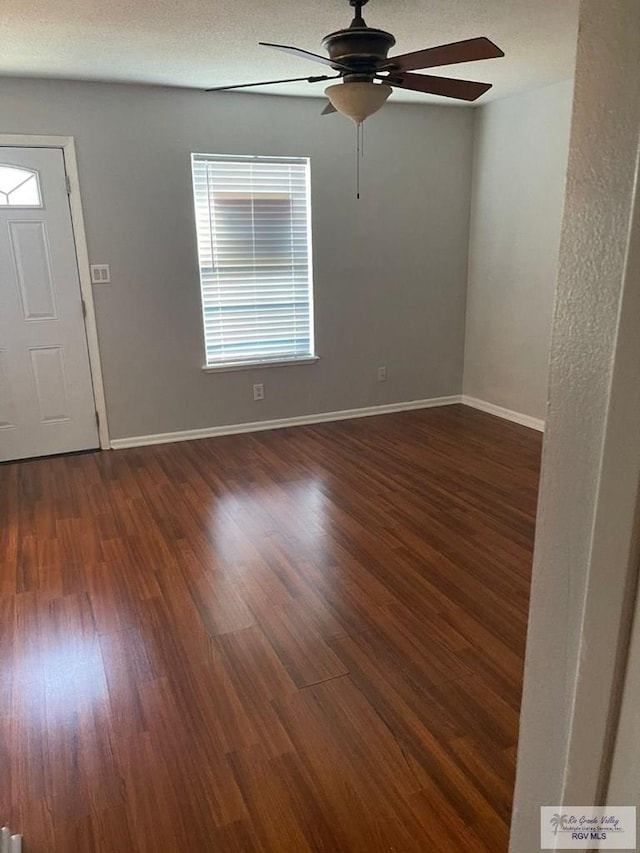 interior space featuring ceiling fan and dark wood-type flooring