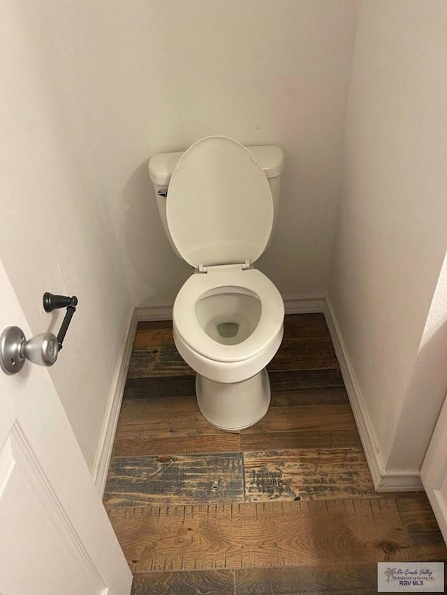 bathroom with hardwood / wood-style floors and toilet