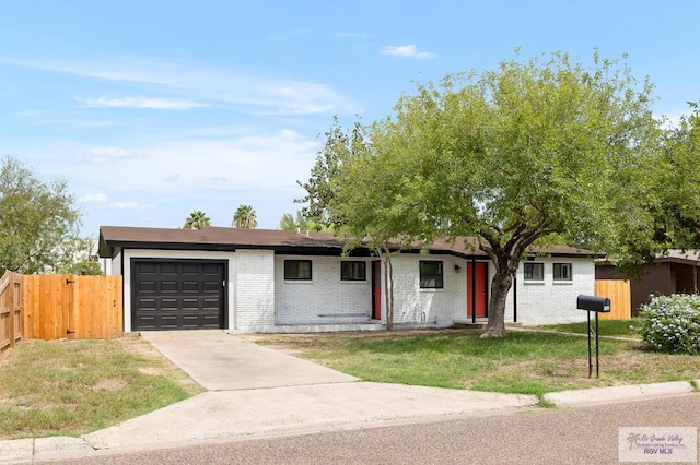 ranch-style home with a front lawn and a garage