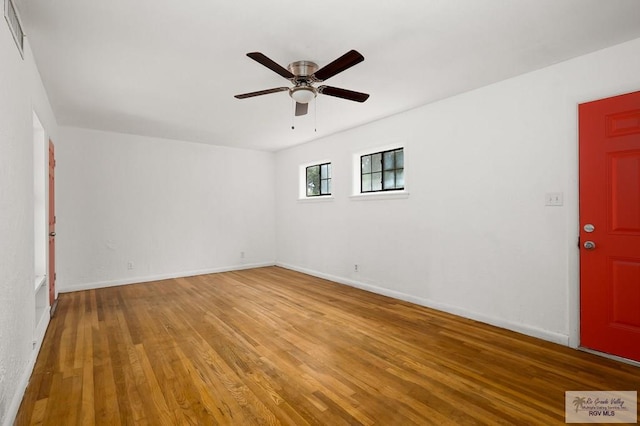 empty room with ceiling fan and wood-type flooring