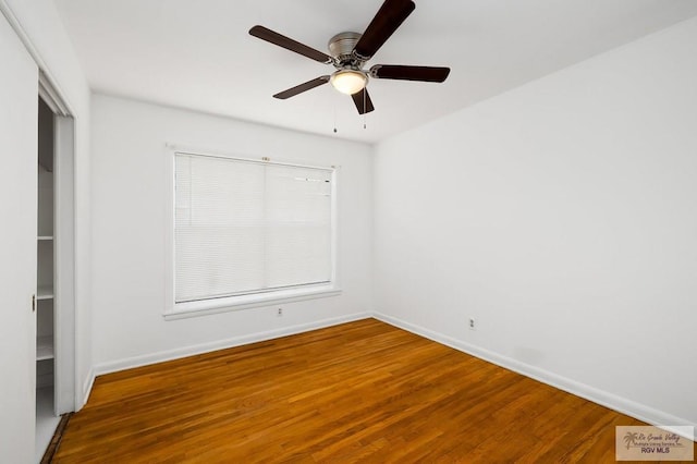 unfurnished room with ceiling fan and wood-type flooring